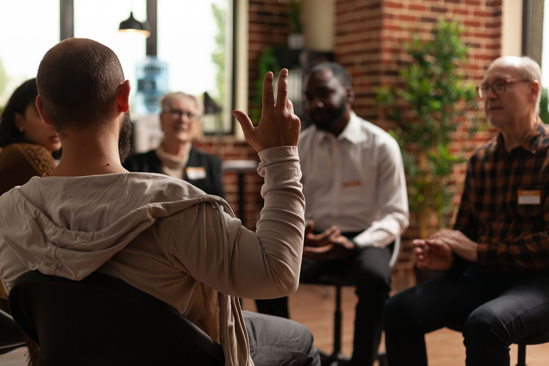 Man with addiction sharing health problems with group at aa meeting